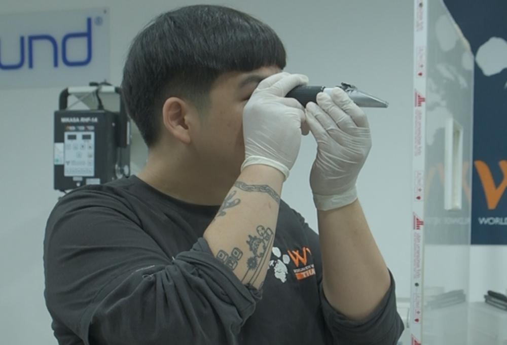 Figure 2. A clinician looks through a refractometer to read urine specific gravity.