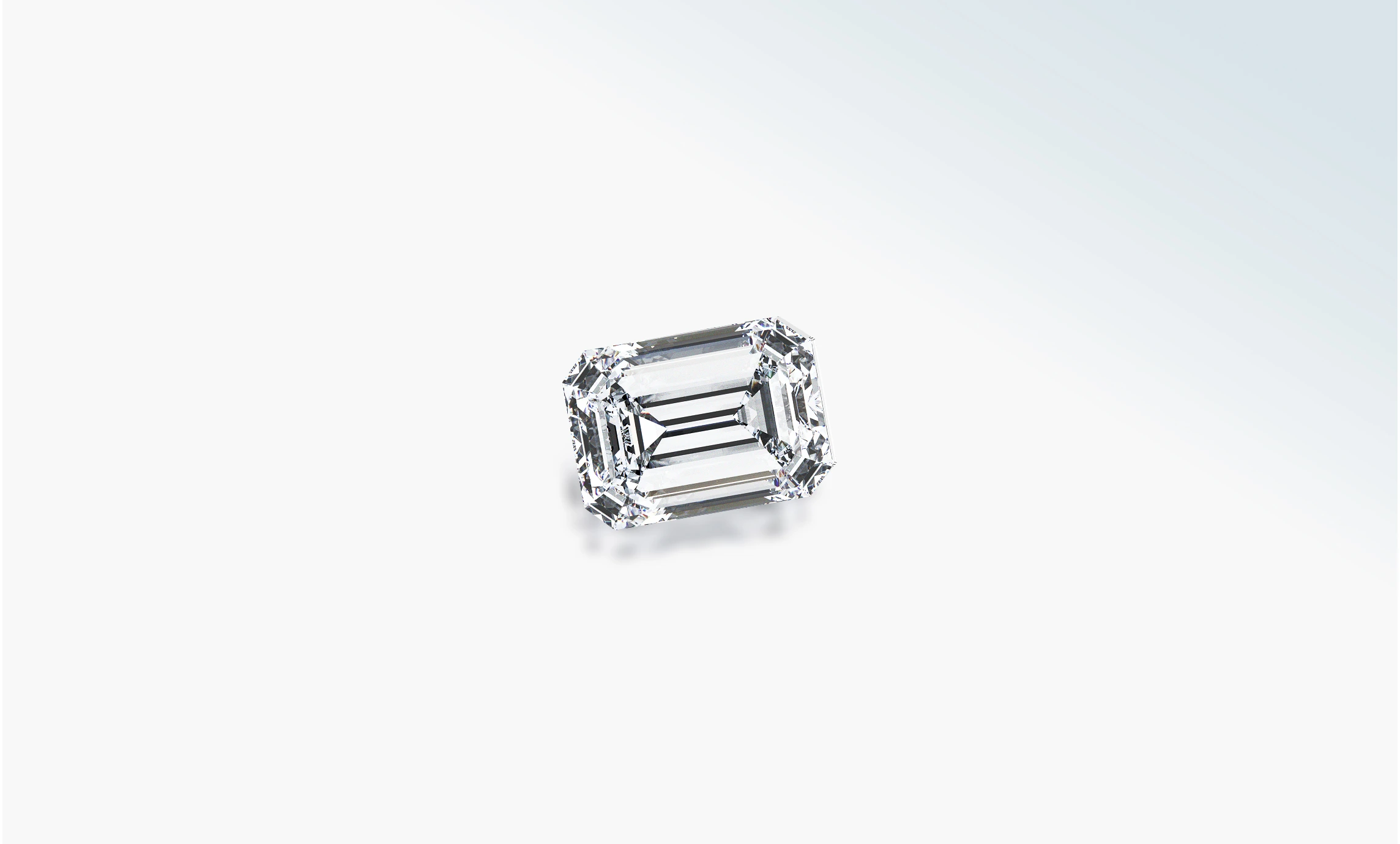 Loose rectangular emerald-cut diamond on a pale background
