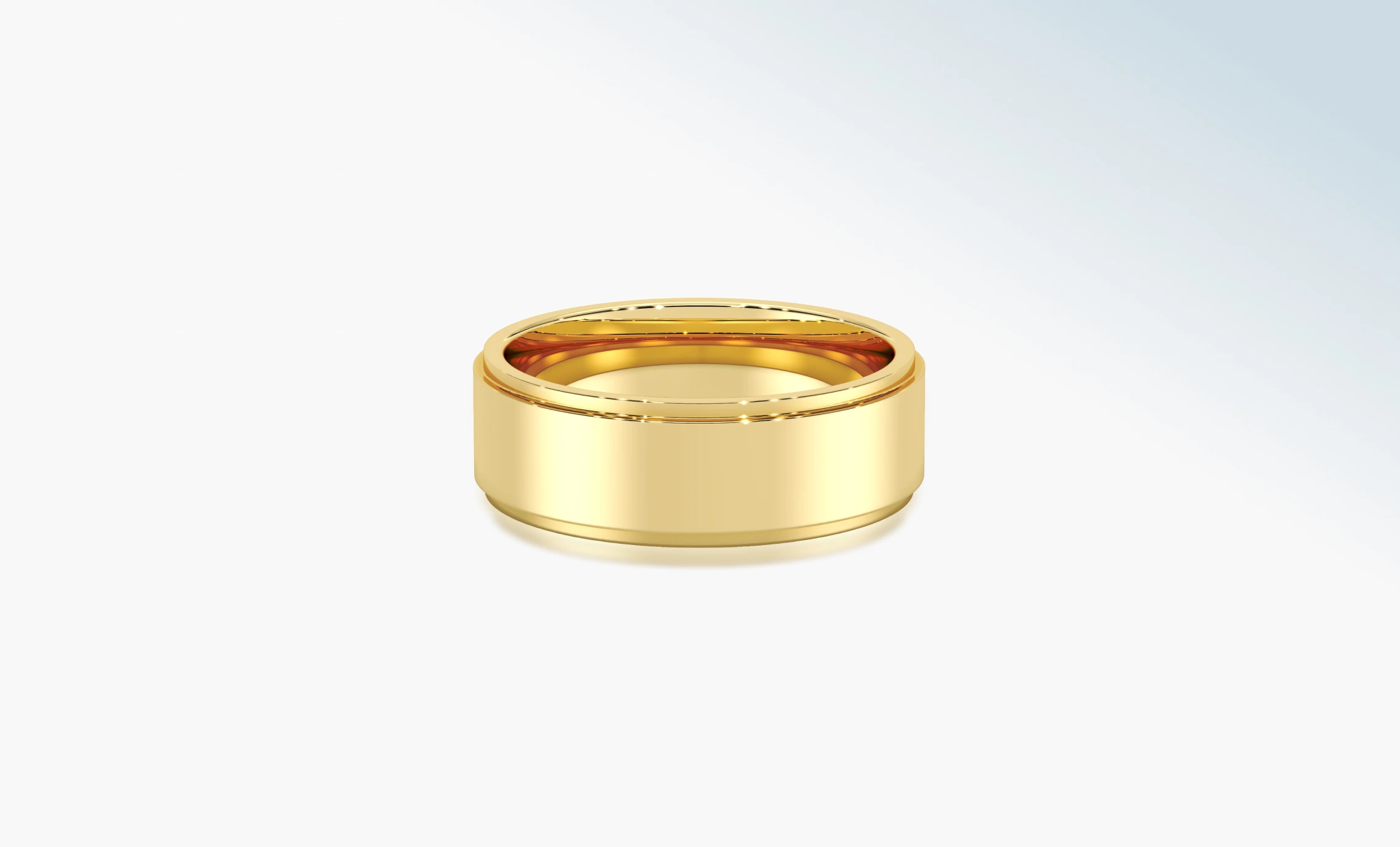 Polished 18K yellow gold wedding band on a pale background