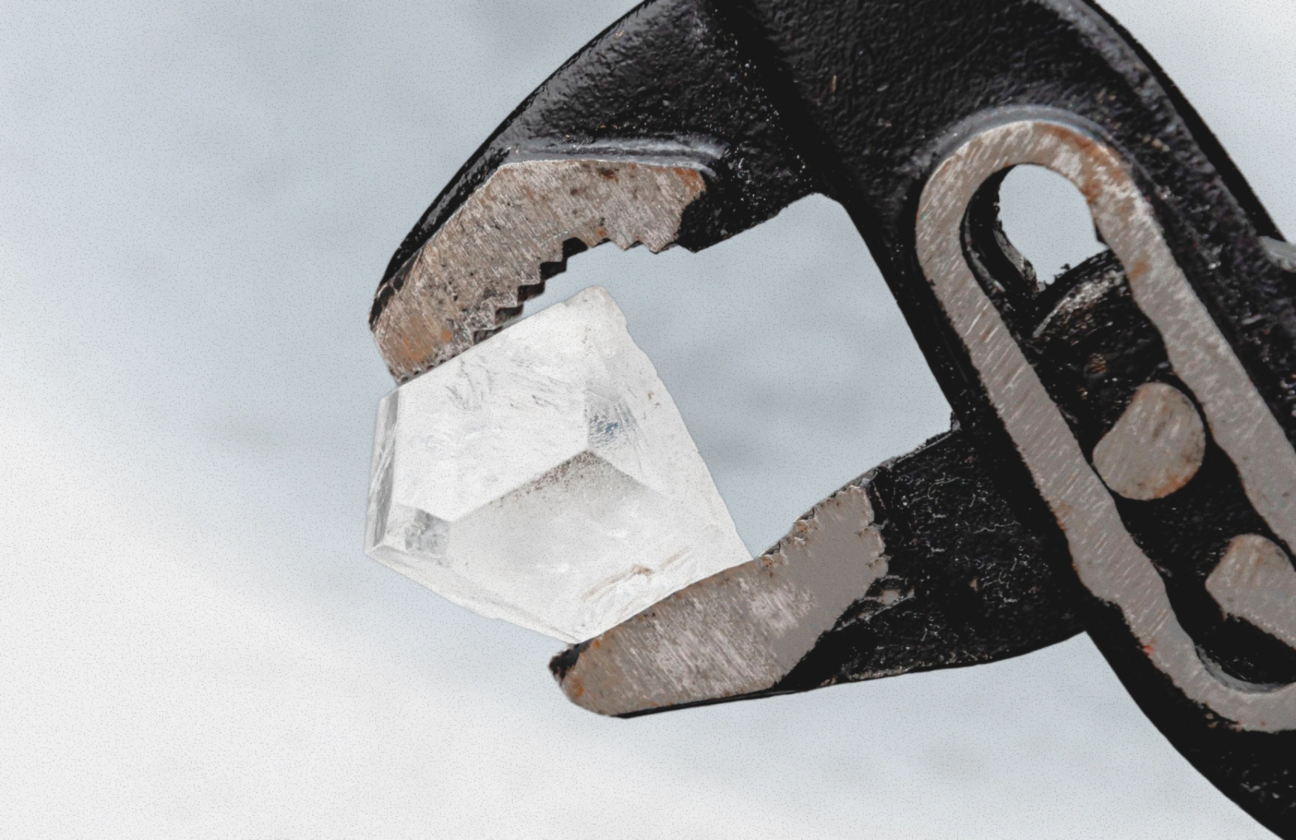 Rough diamond held carefully in a metal tool