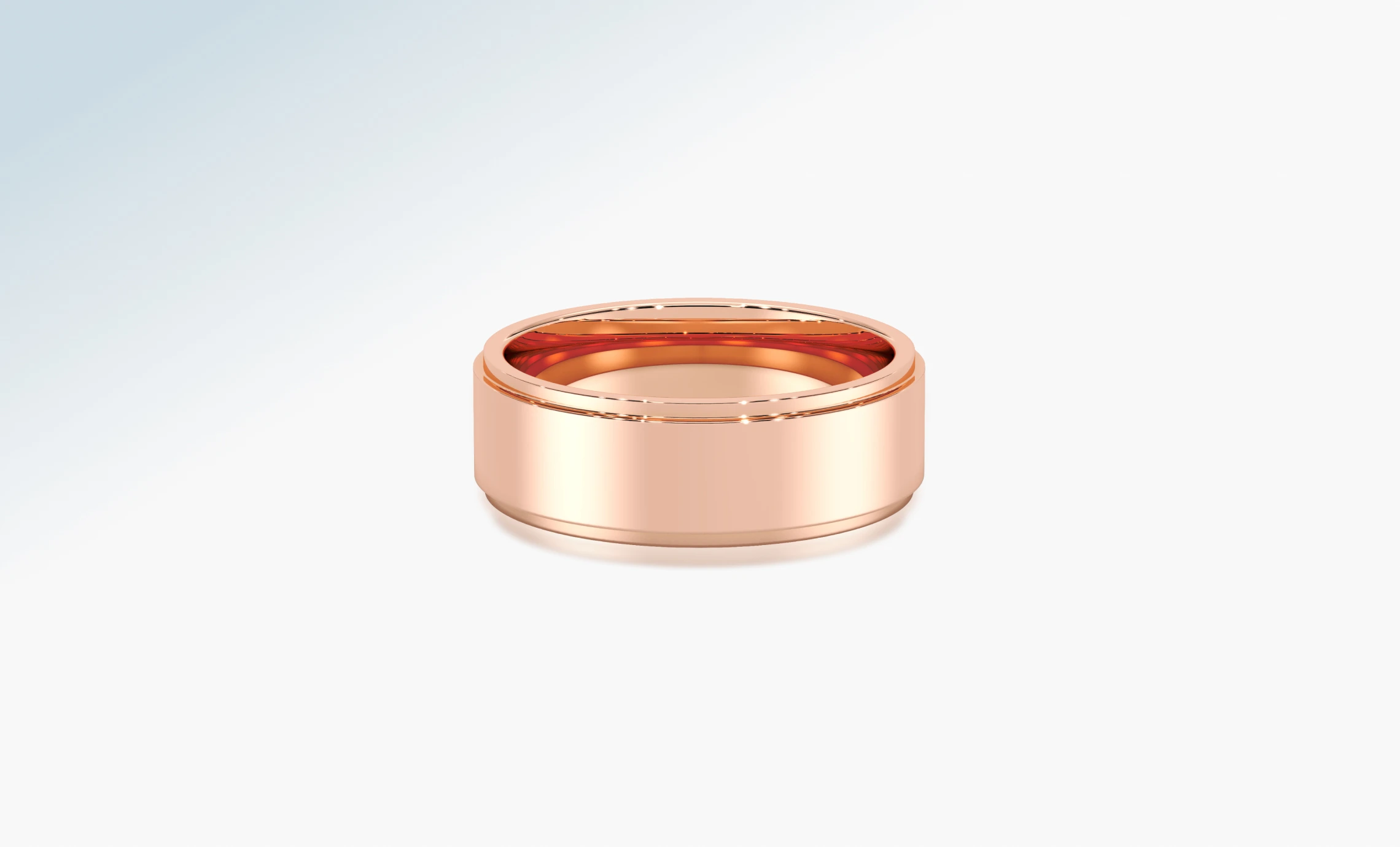 Polished 18K rose gold wedding band on a pale background
