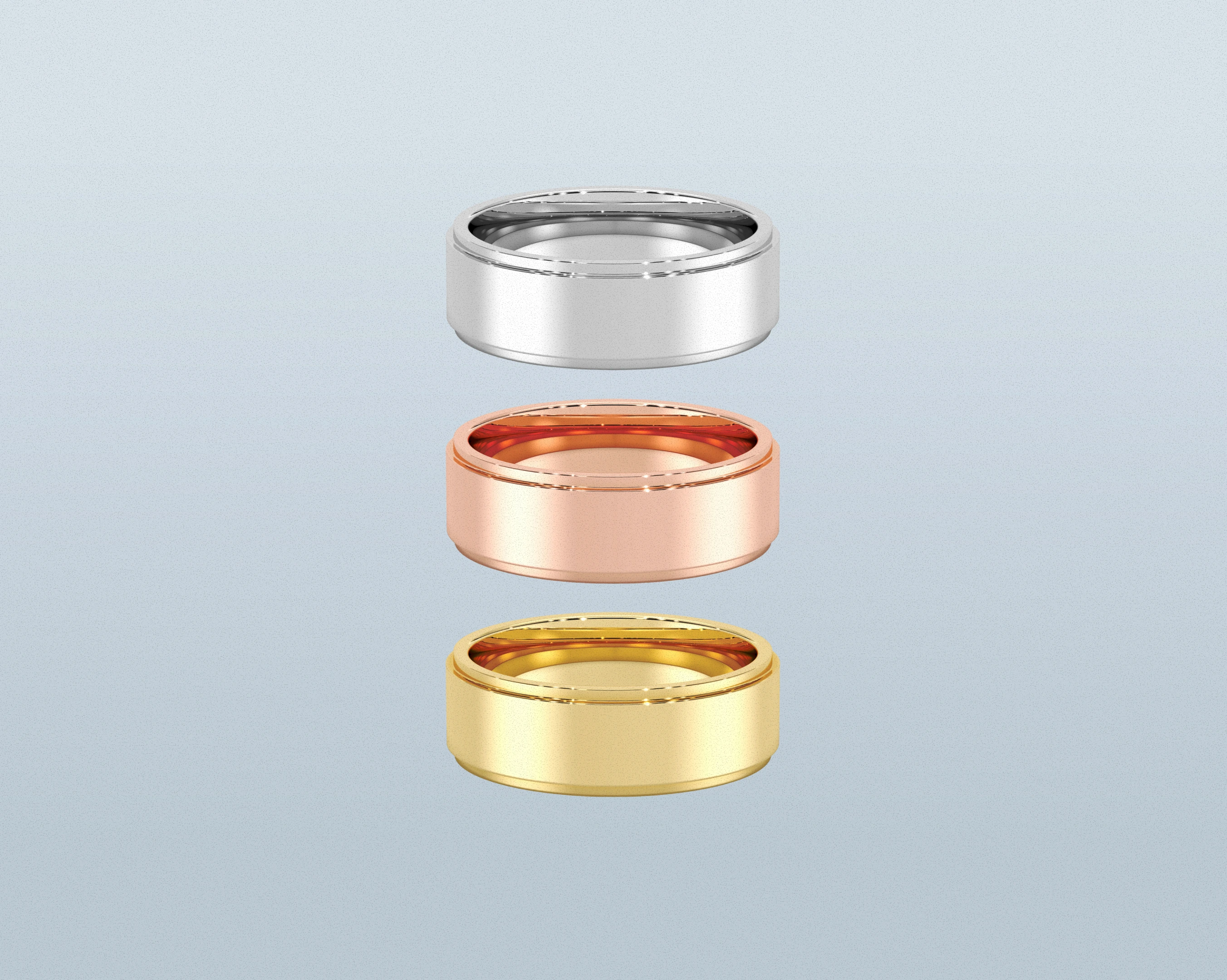 White, rose, and yellow precious-metal wedding bands arranged vertically
