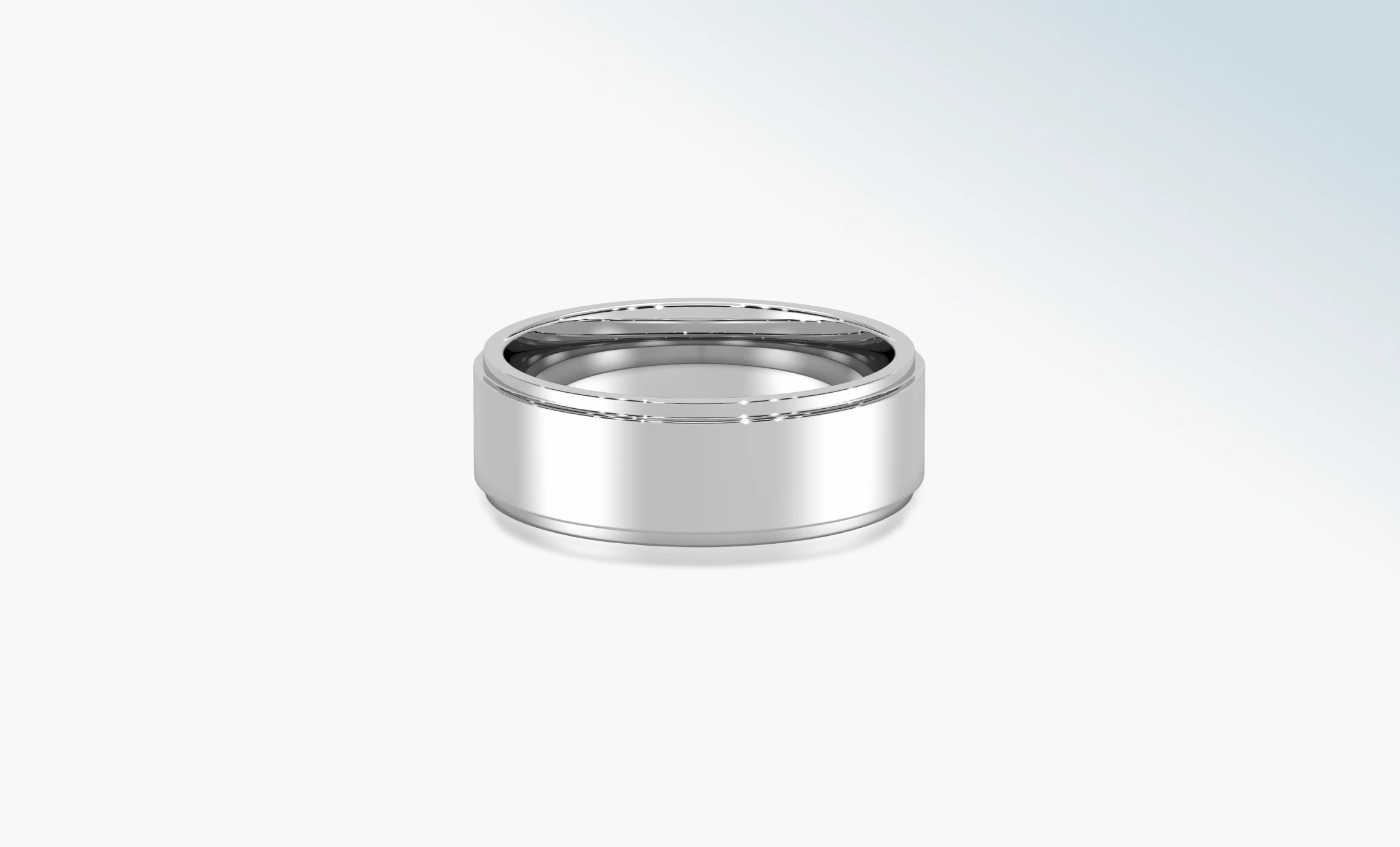 Polished 18K white gold wedding band on a pale background