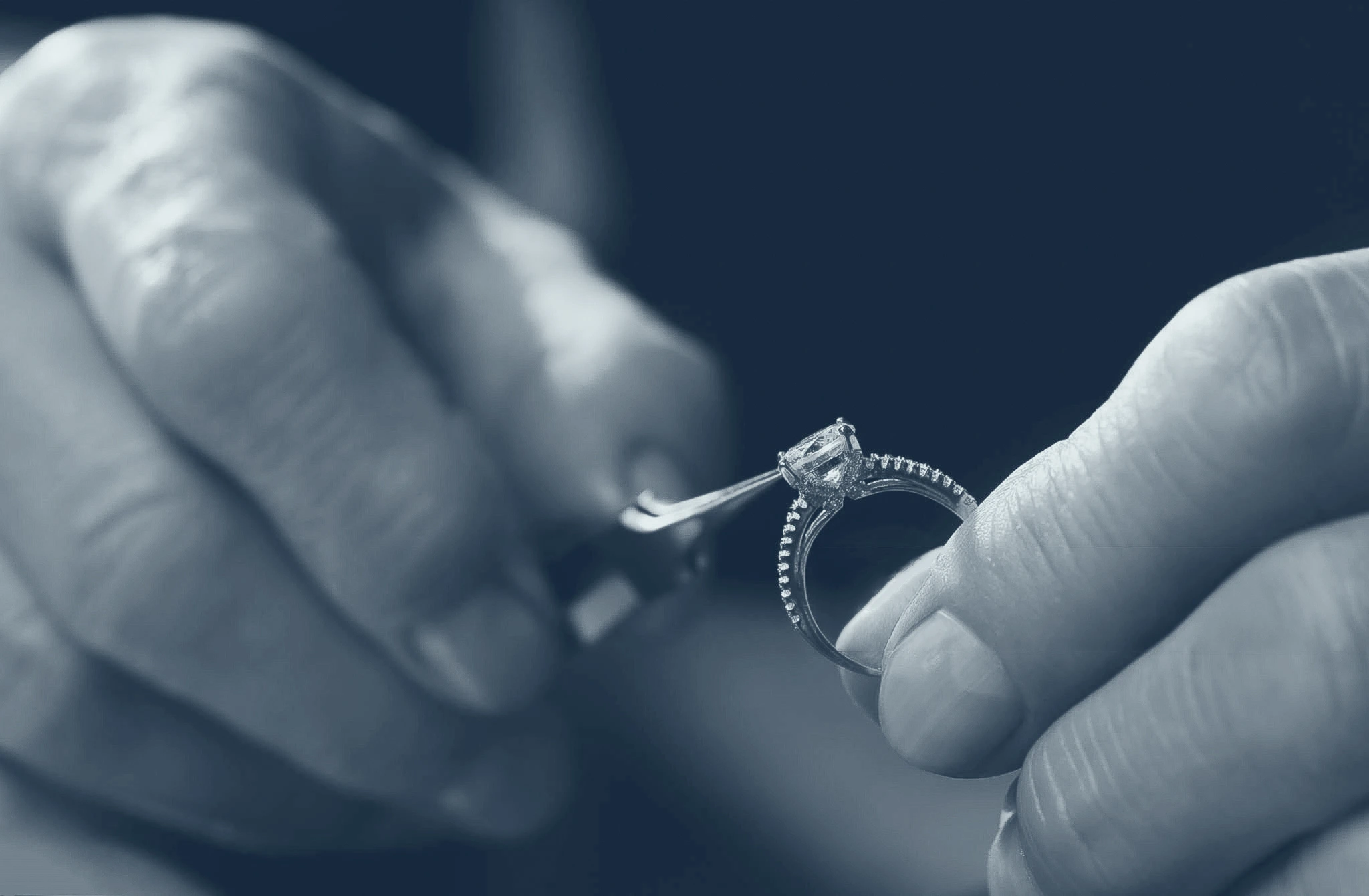 Jeweler refining a diamond engagement ring at the workbench