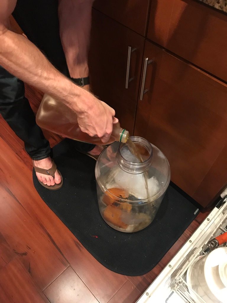 pouring apple juice into fermenter