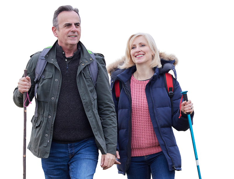 Active middle-aged couple hiking together, staying healthy through outdoor recreation