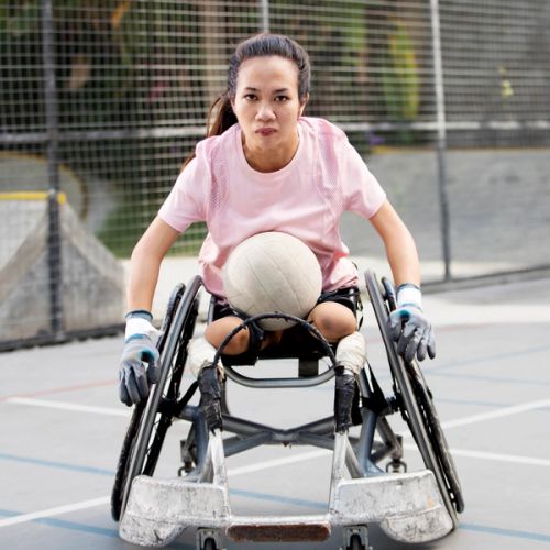 Ratni on a wheelchair with a ball on her lap