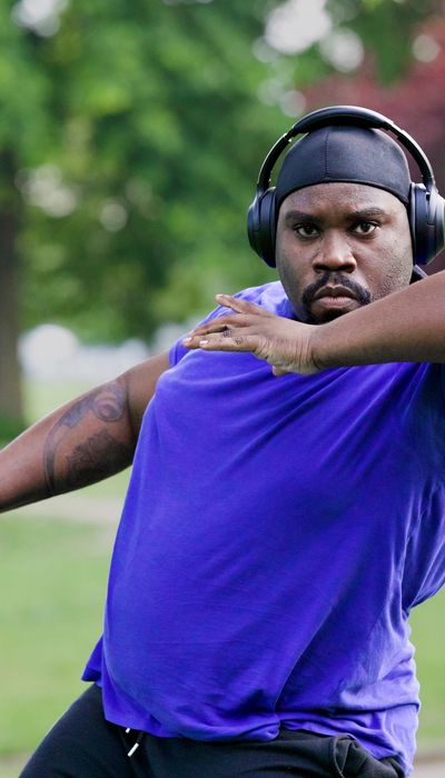 Man in purple sports top with headphones