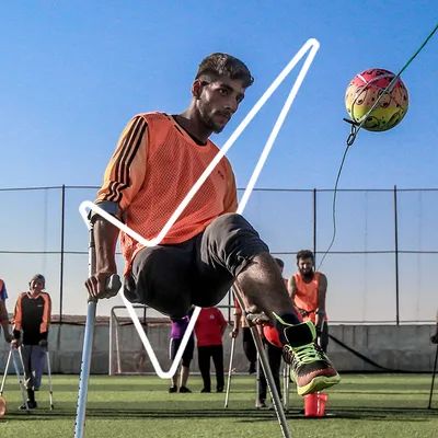 Young soccer player using crutches enjoys playing keep up