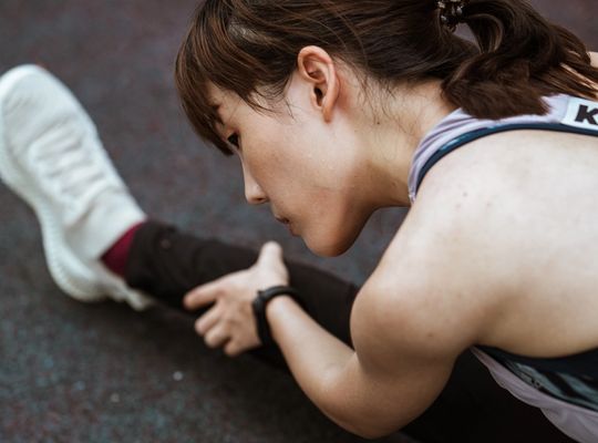 woman in sports gear stretching before a run, sweat rash