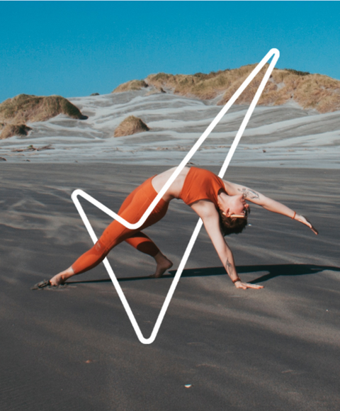 Woman doing a yoga pose on the beach