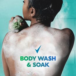 Woman washing her back with tagline body wash and soak