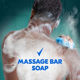 Man washing himself with tagline massage bar soap