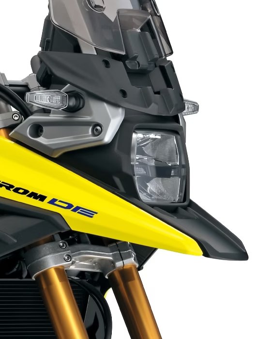 Detalle del faro delantero de la motocicleta Suzuki V-Strom 1050DE amarilla