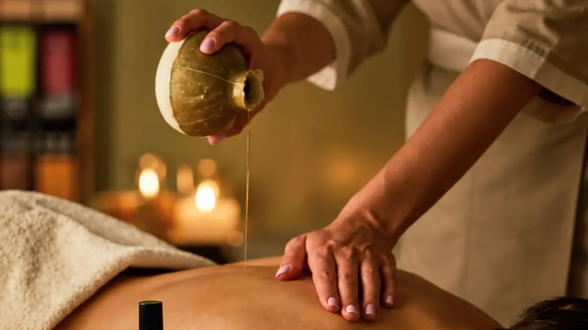 Luxury spa massage treatment with warm oil being poured onto a guest’s back, representing wellness and relaxation during a Mykonos holiday.