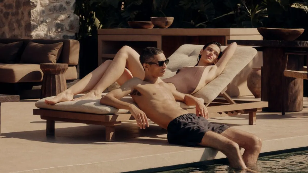 A couple relaxing by the pool at a luxury villa in Mykonos.