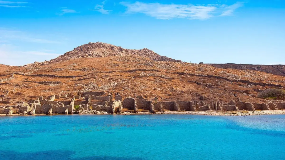 Ancient ruins of Delos Island overlooking the crystal-clear Aegean Sea near Mykonos, Greece.