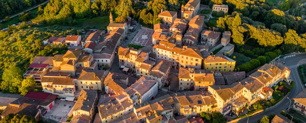 A drone view of the beautiful town of Castelnuovo Berardenga in the golden hour