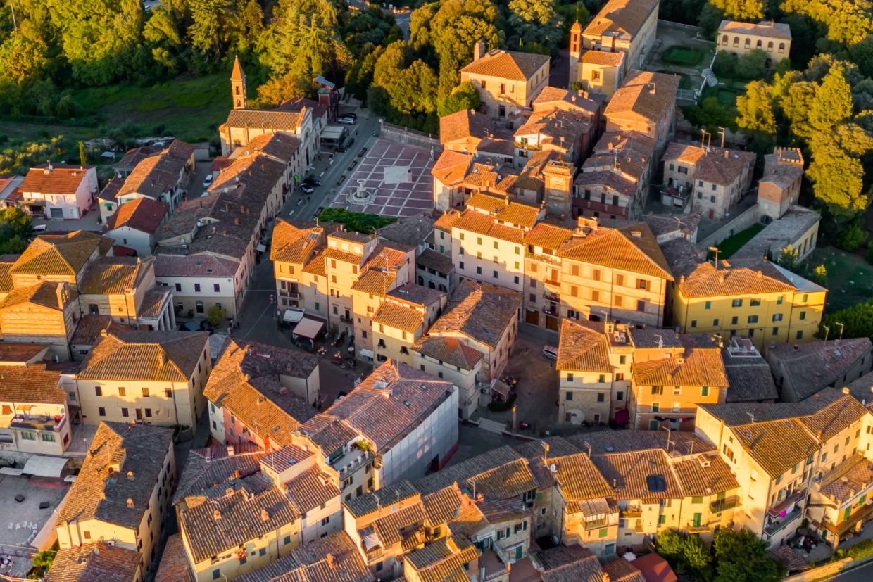 A drone view of the beautiful town of Castelnuovo Berardenga in the golden hour