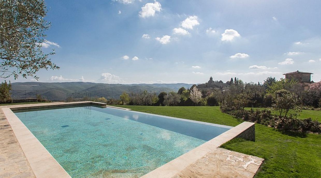 The salt-water infinity pool of Villa Le Barone looking over the Conca d’Oro vineyards of Panzano in Chianti