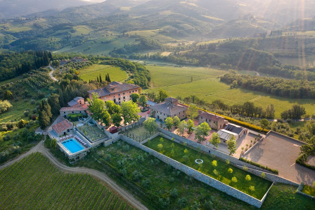 Aerial view of Vignamaggio between Greve and Panzano: the rose-coloured Renaissance villa with its walled Italian gardens and pool, among vineyards and olive groves