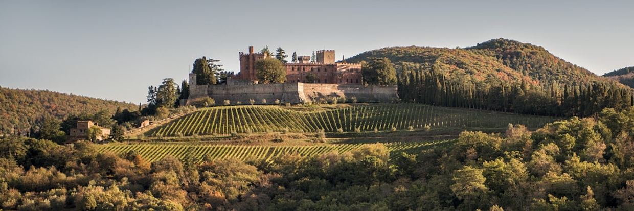 The dramatic battlements of Castello di Brolio rising above Chianti Classico vines near Gaiole
