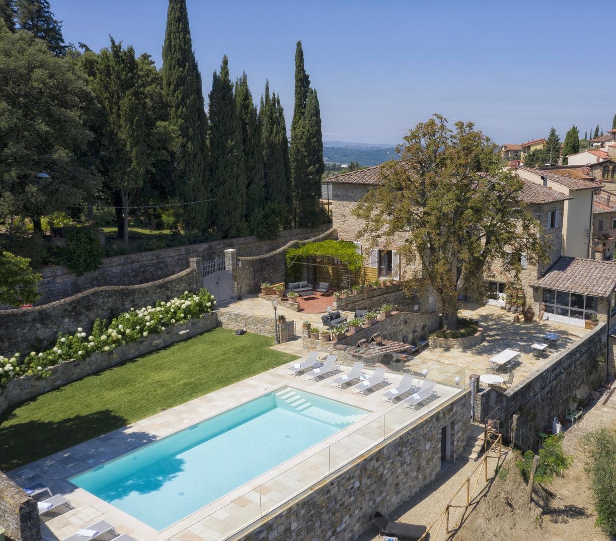 The heated pool and terraced garden of Villa La Petraia, a historic villa in the heart of Panzano in Chianti