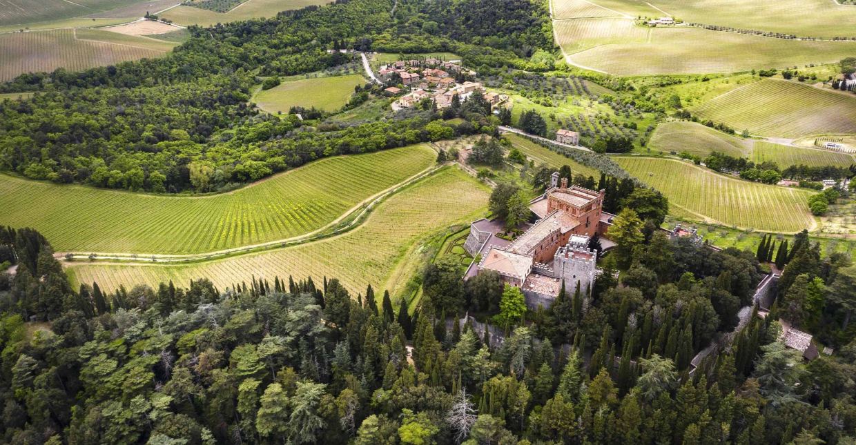 A sun-lit dining room within the Castello di Brolio estate, table set for lunch with estate wines
