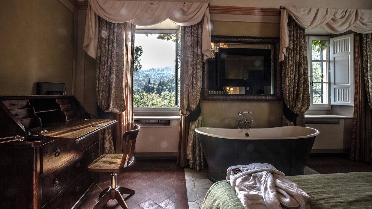 The vine-covered terrace of Villa Bordoni boutique hotel above Greve in Chianti