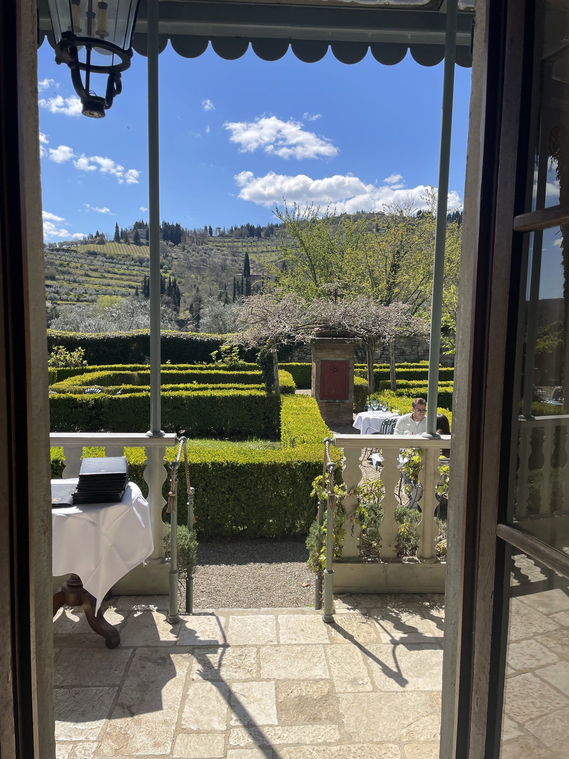 The hilltop terrace of Il Guardingo osteria above Greve in Chianti, with panoramic views across the vine-covered hills