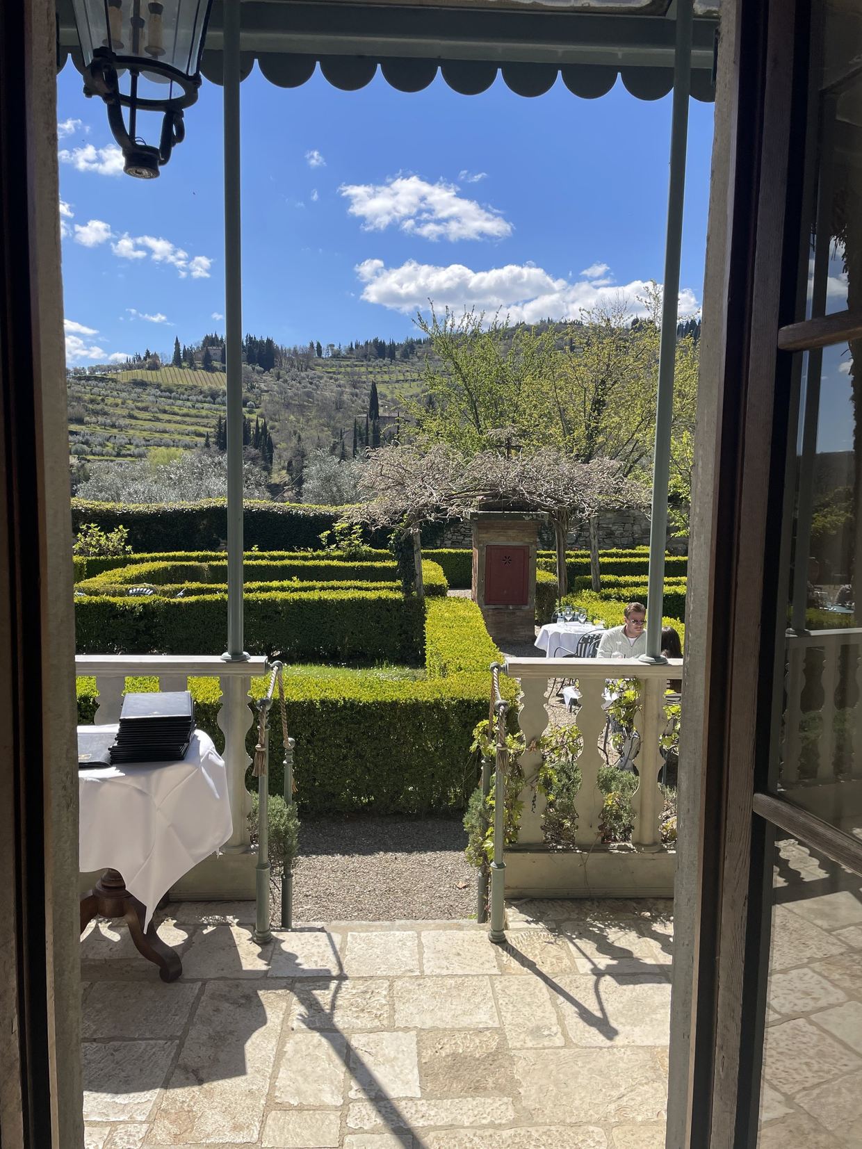 The hilltop terrace of Il Guardingo osteria above Greve in Chianti, with panoramic views across the vine-covered hills