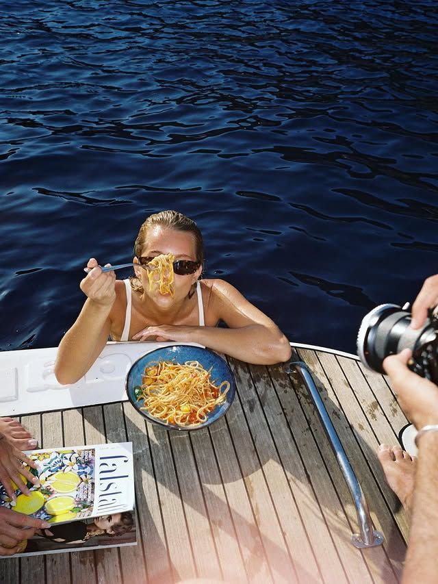 A bowl of pasta shared beside a yacht's swim platform