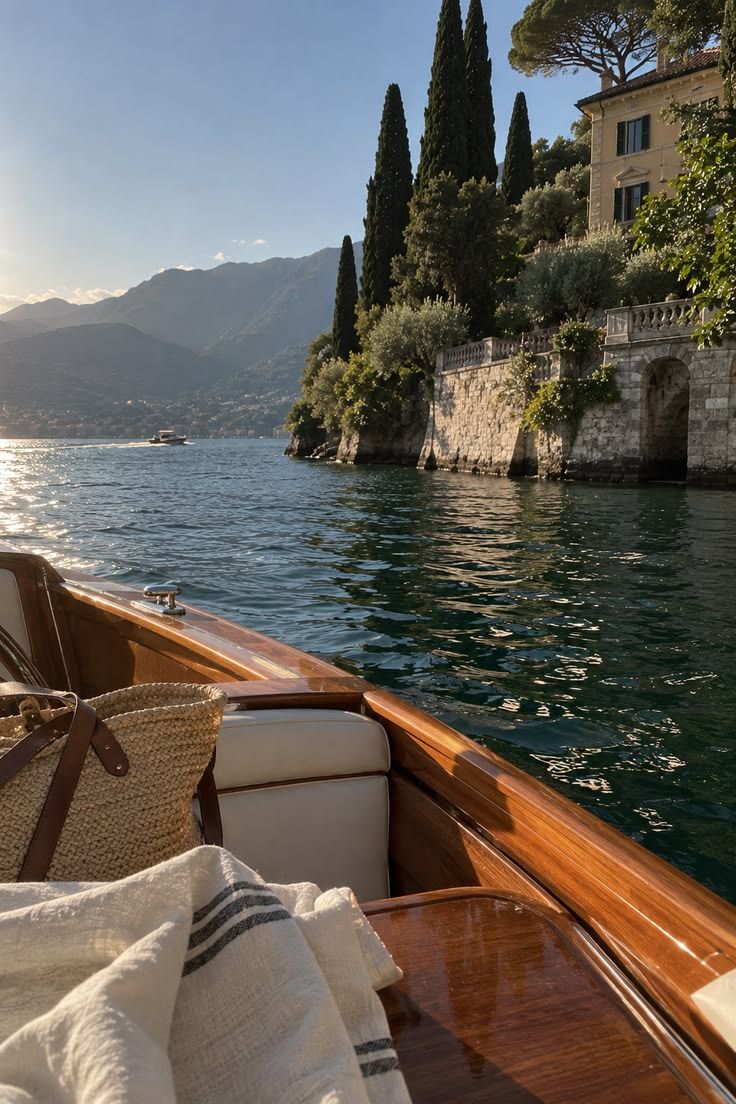 View from a boat passing a stone building on a lakeshore