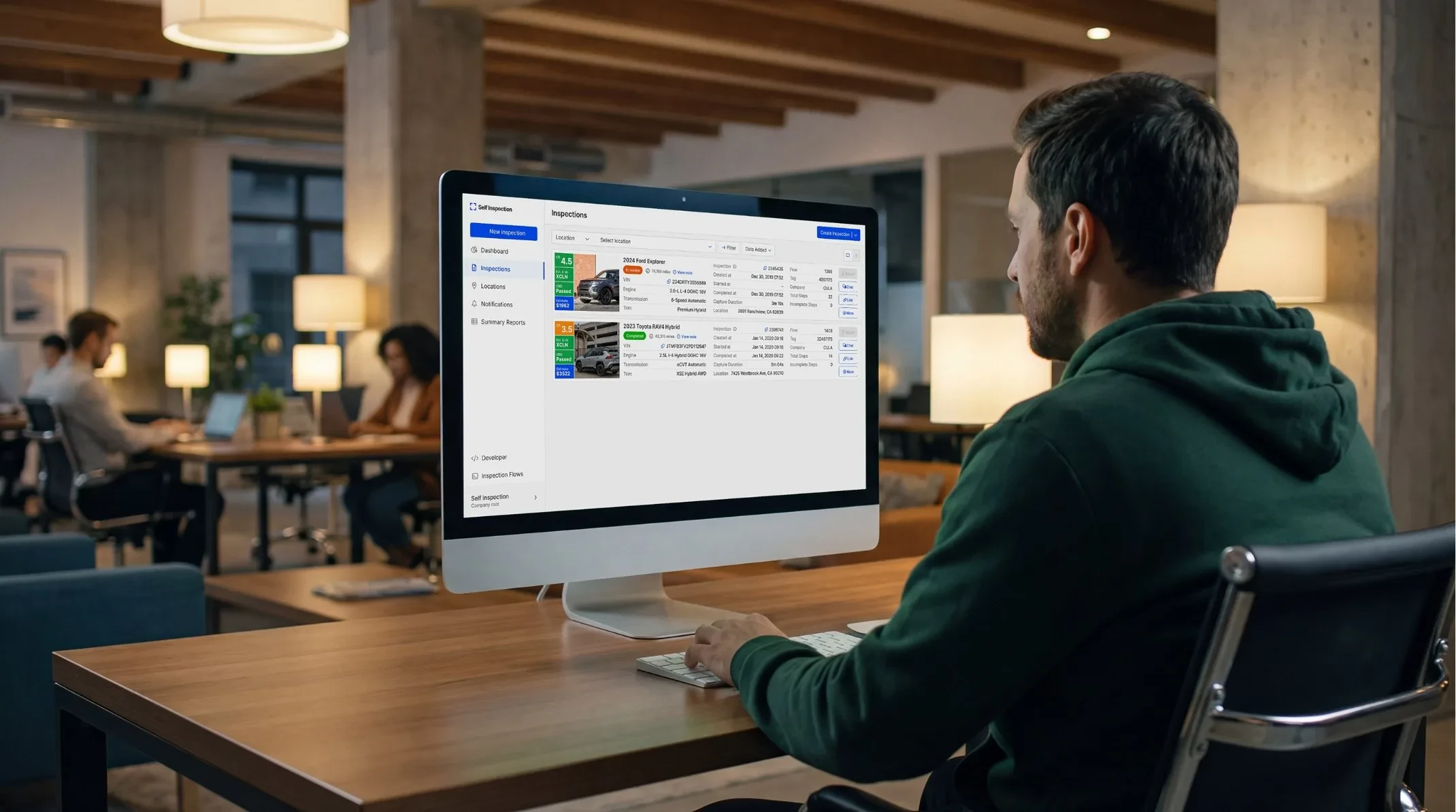 Operations manager reviewing inspections in the Self Inspection web app at an office desk