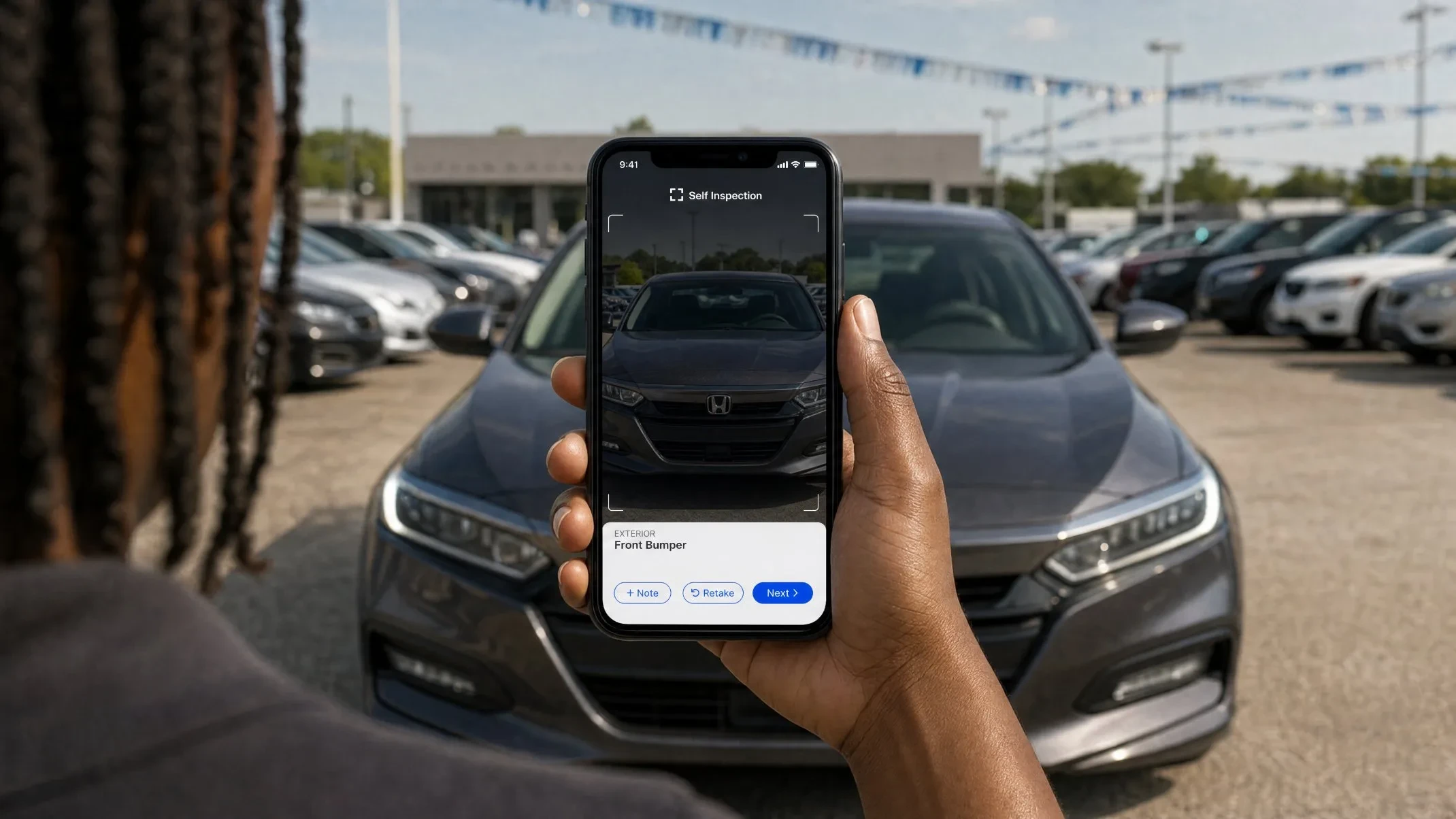 Inspector capturing a car's front bumper with the Self Inspection app on a dealer lot