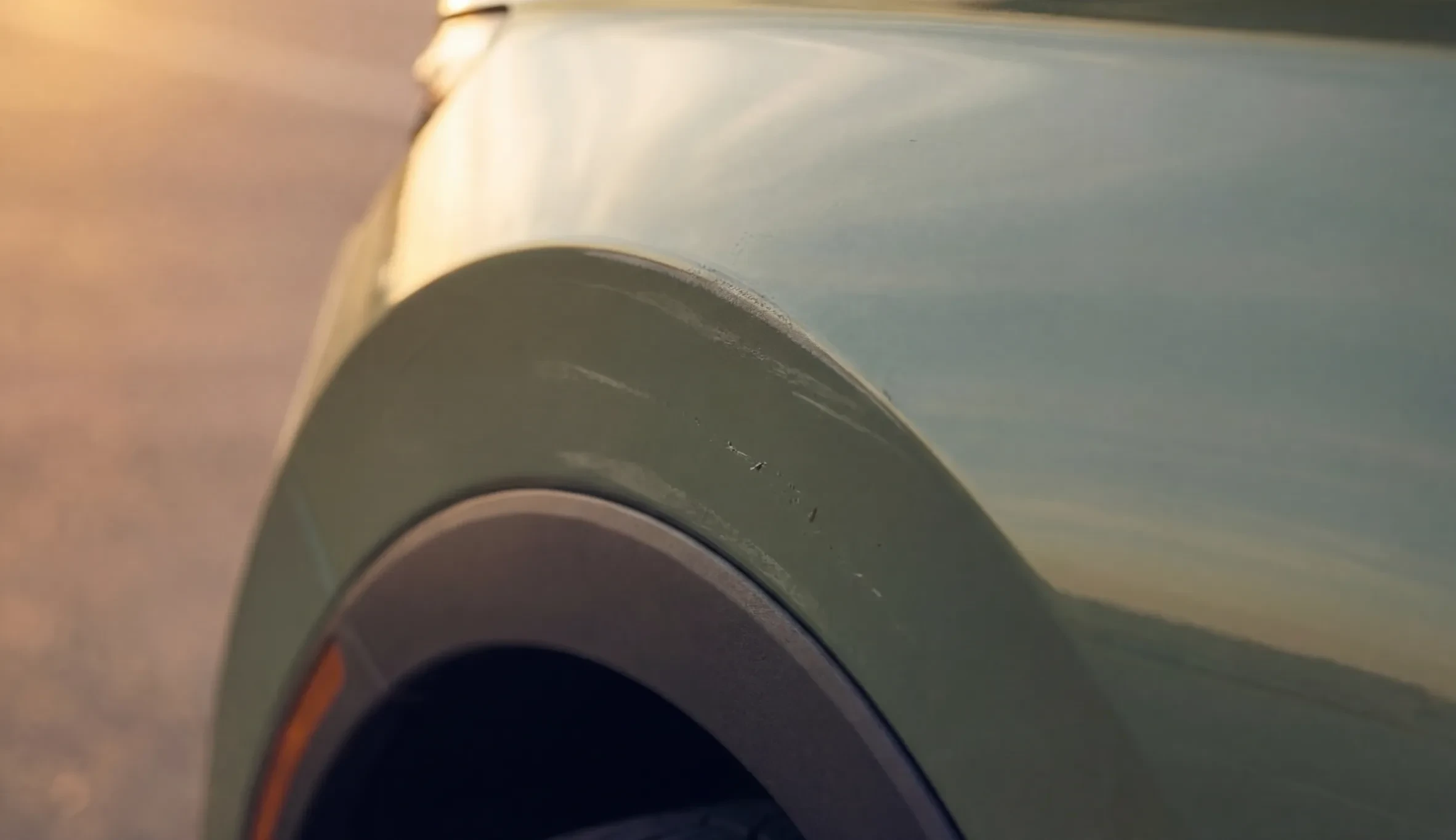 Scuffs along a rear wheel arch, flagged with a repair estimate