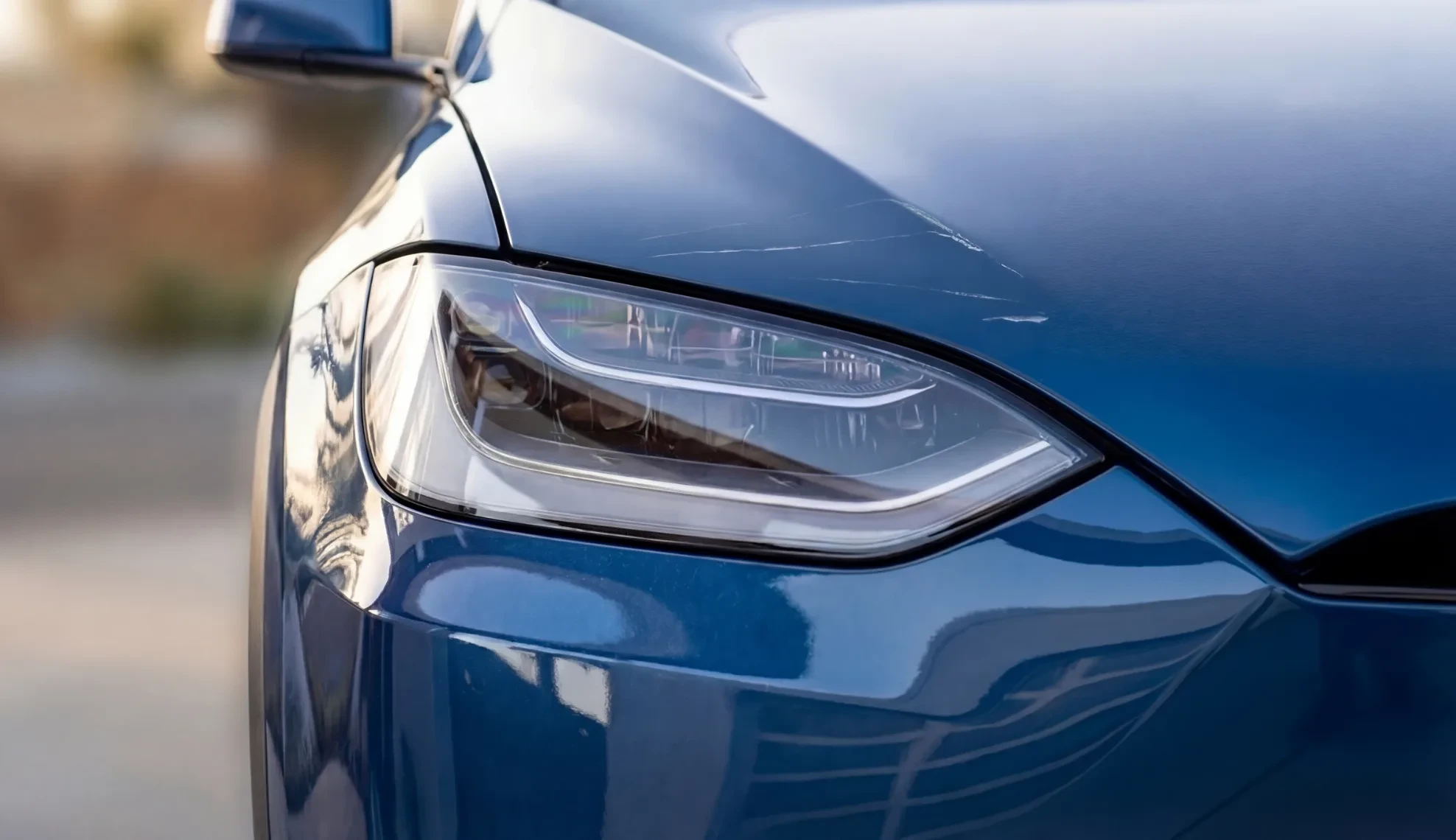 Scratches on the hood above a headlight
