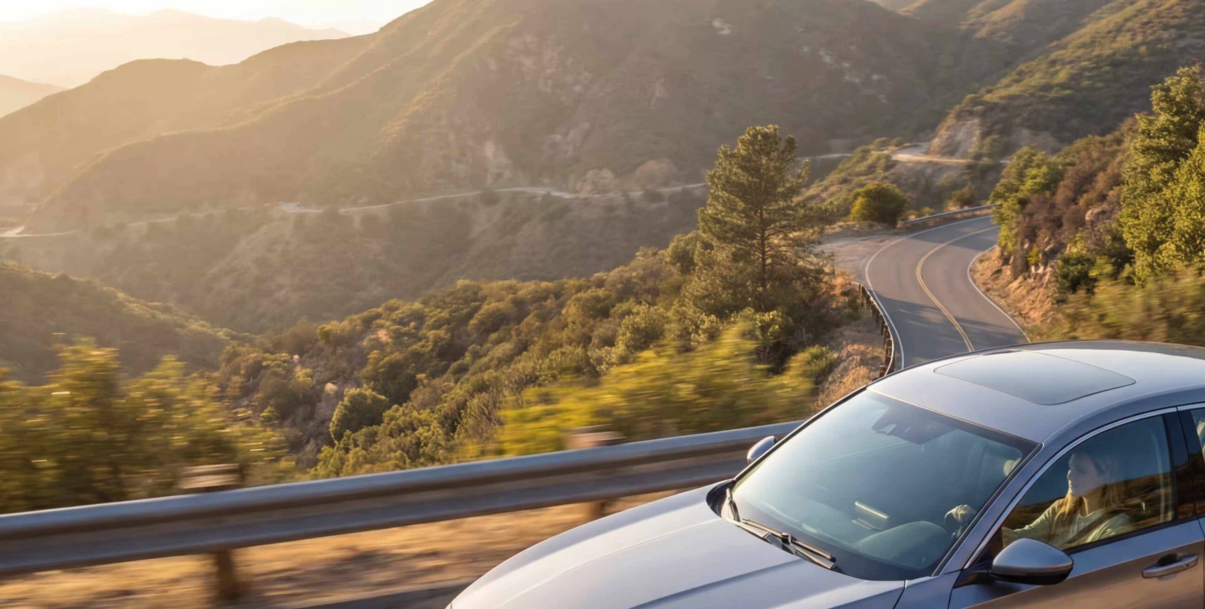 Silver car on a winding mountain road