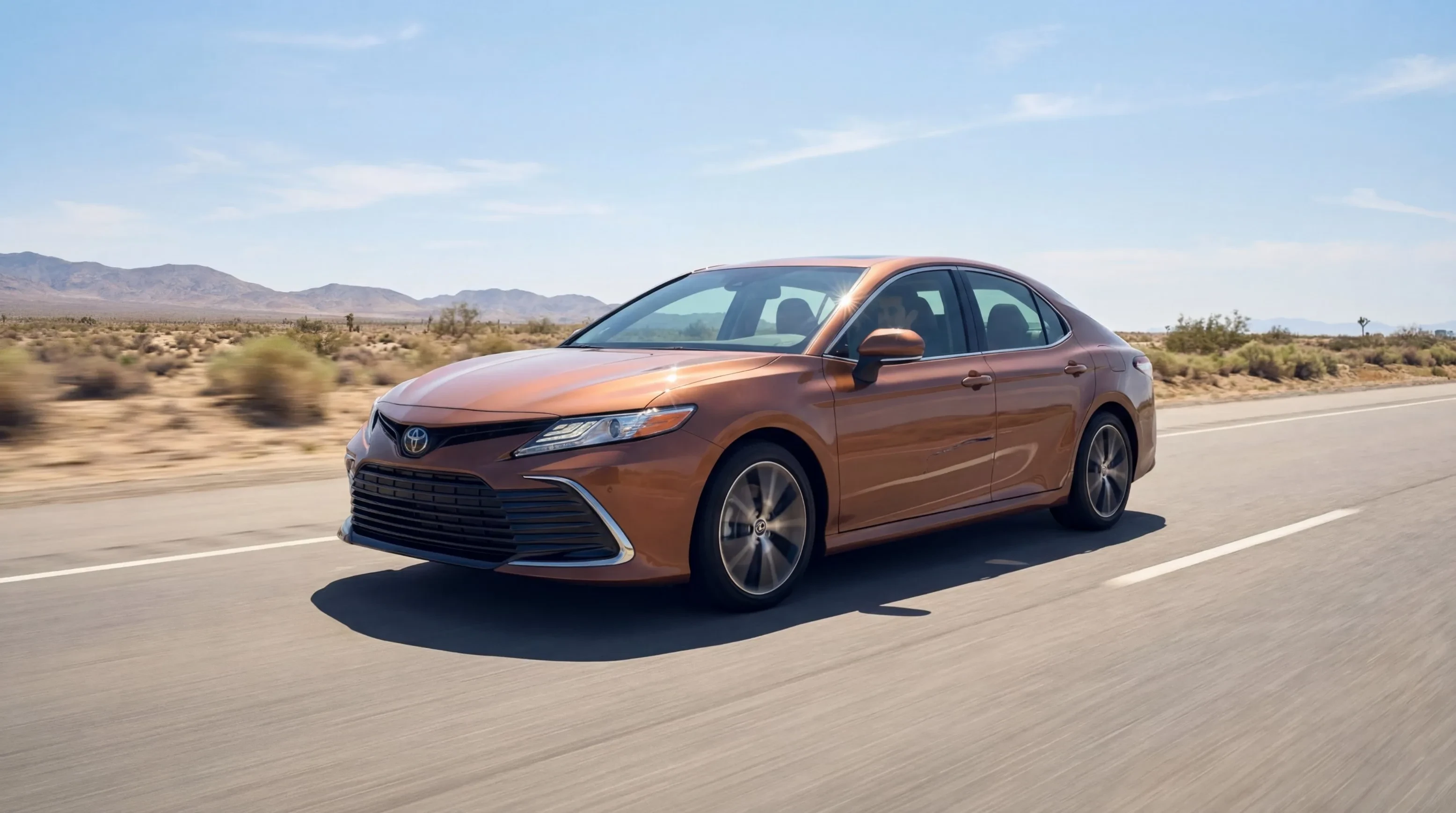 Sedan driving on a desert highway