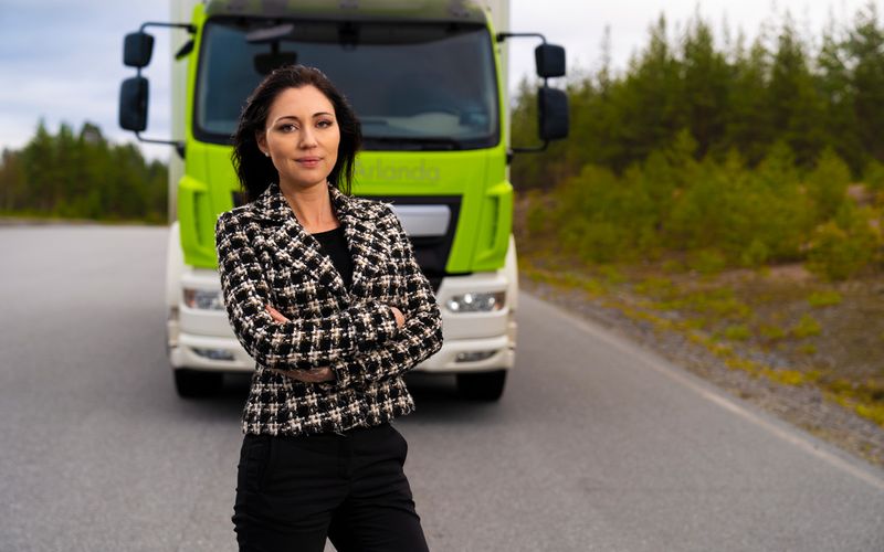 Woman standing in fort of truck