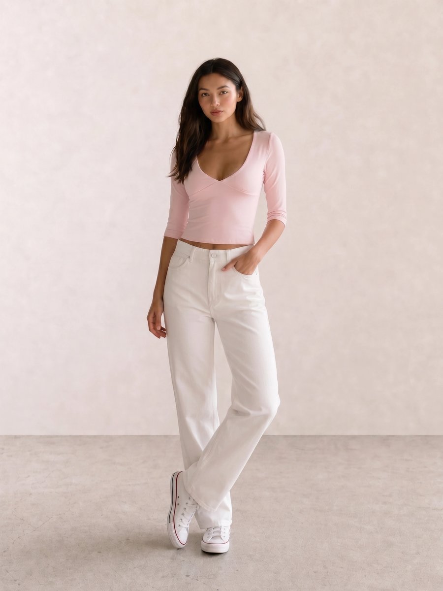 Basic casual outfit with a pink V-neck crop top, white wide-leg jeans, and white canvas sneakers