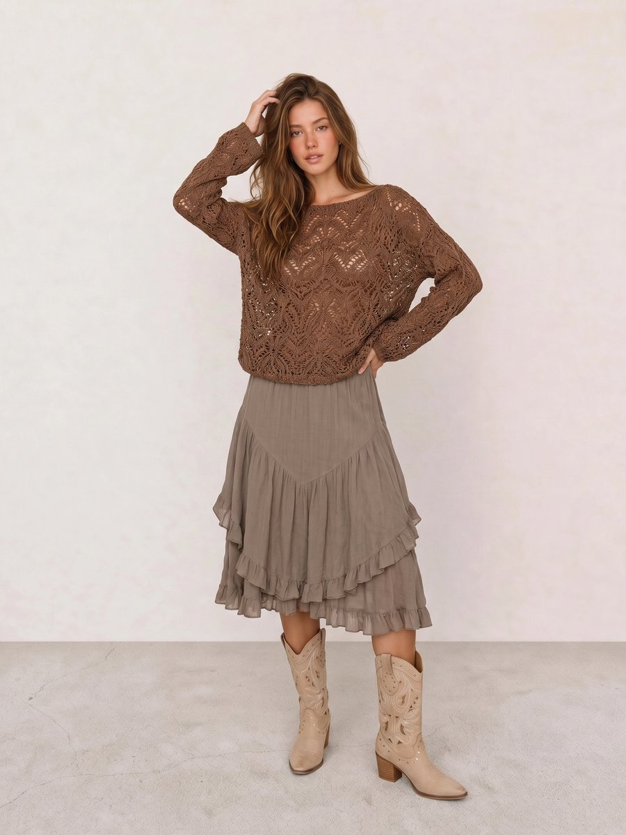 Boho outfit with a brown crochet knit sweater, taupe ruffle midi skirt, and cream studded cowboy boots