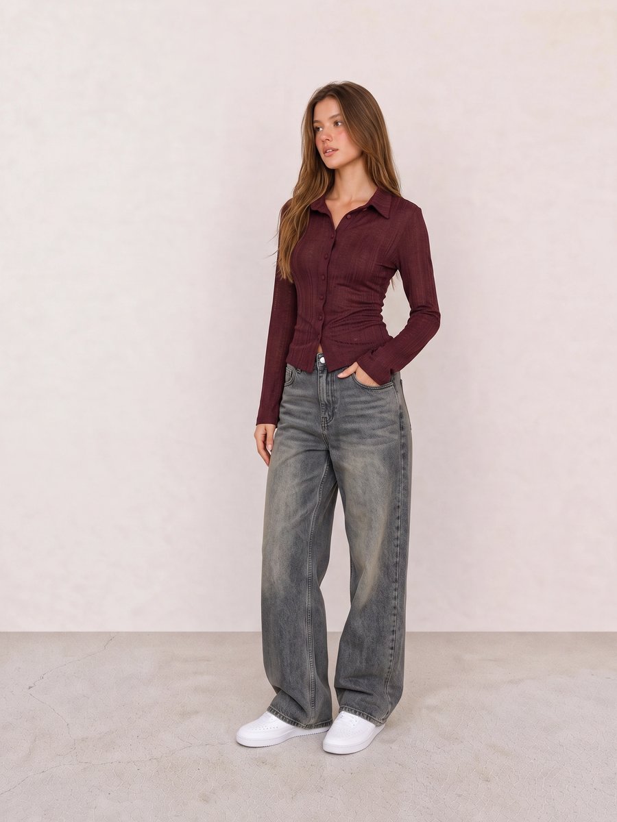 Student wearing a fitted burgundy shirt, washed grey wide-leg jeans, and white sneakers