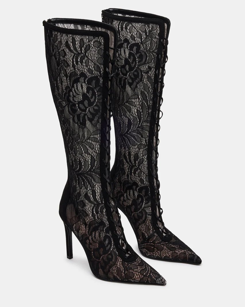 Black lace lace-up knee boots styled with a sheer lace halter top and twist-front midi skirt