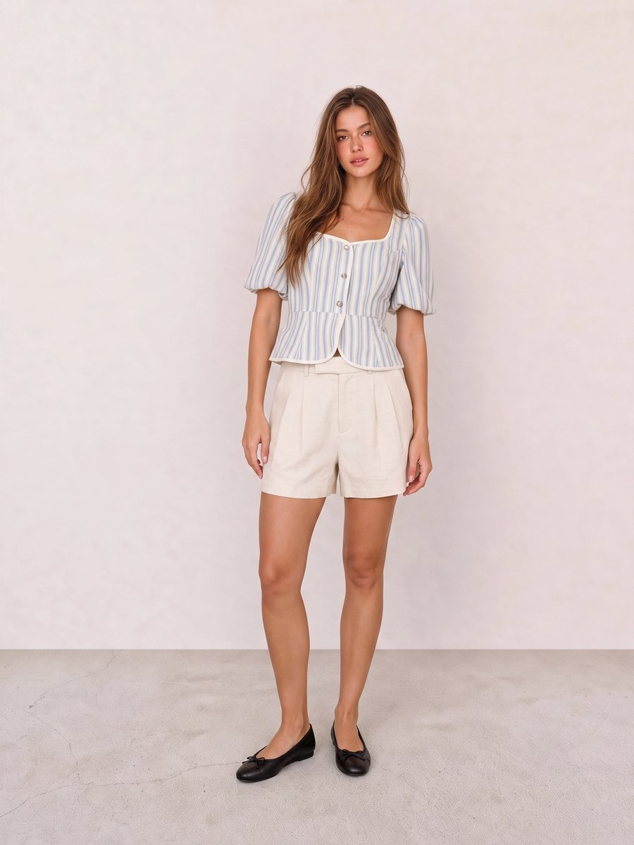 Old money look with blue striped puff-sleeve peplum blouse & beige pleated tailored shorts and black bow ballet flats