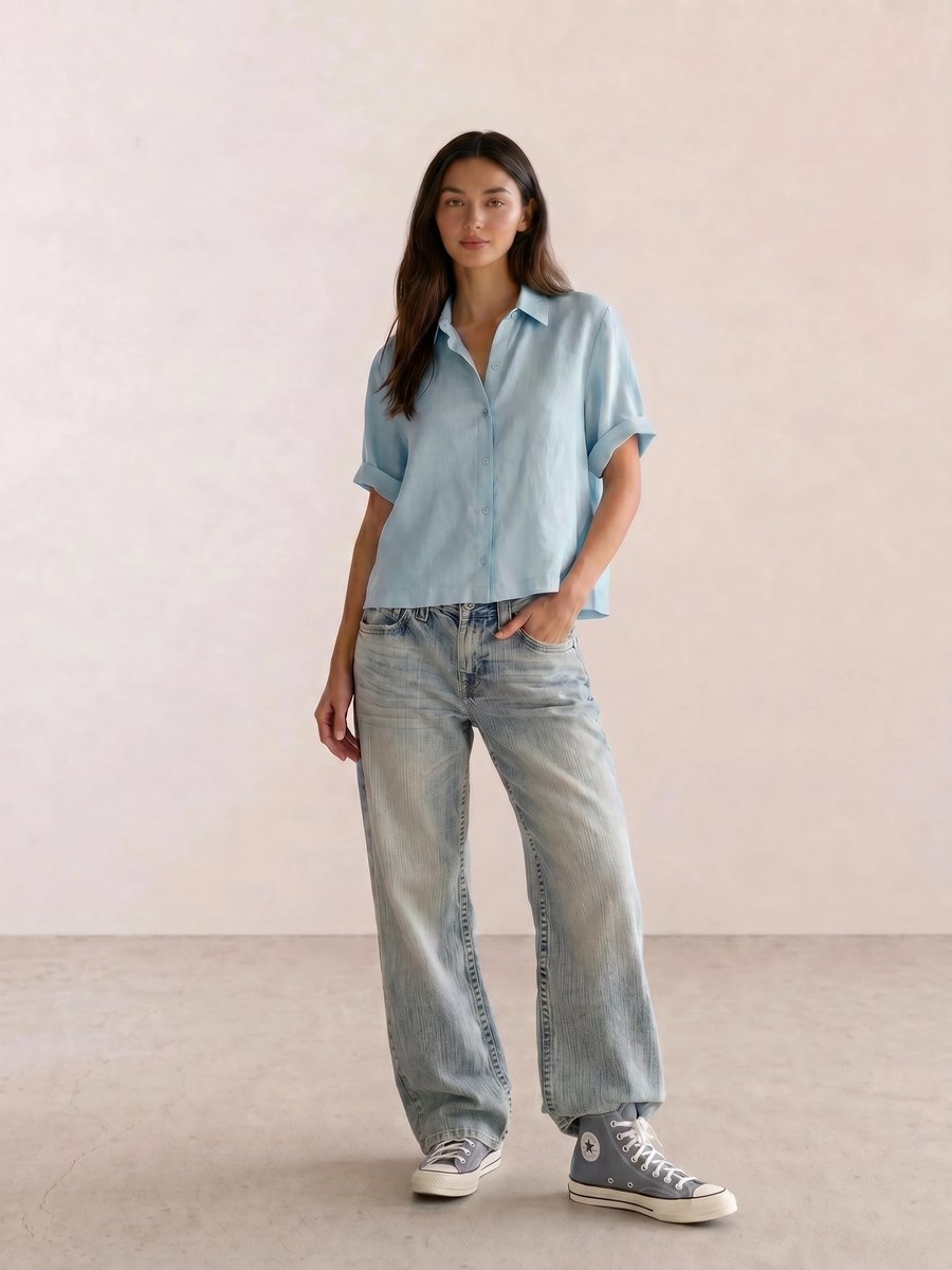 Basic casual outfit with a light blue linen shirt, baggy jeans, and slate-blue Converse high-tops