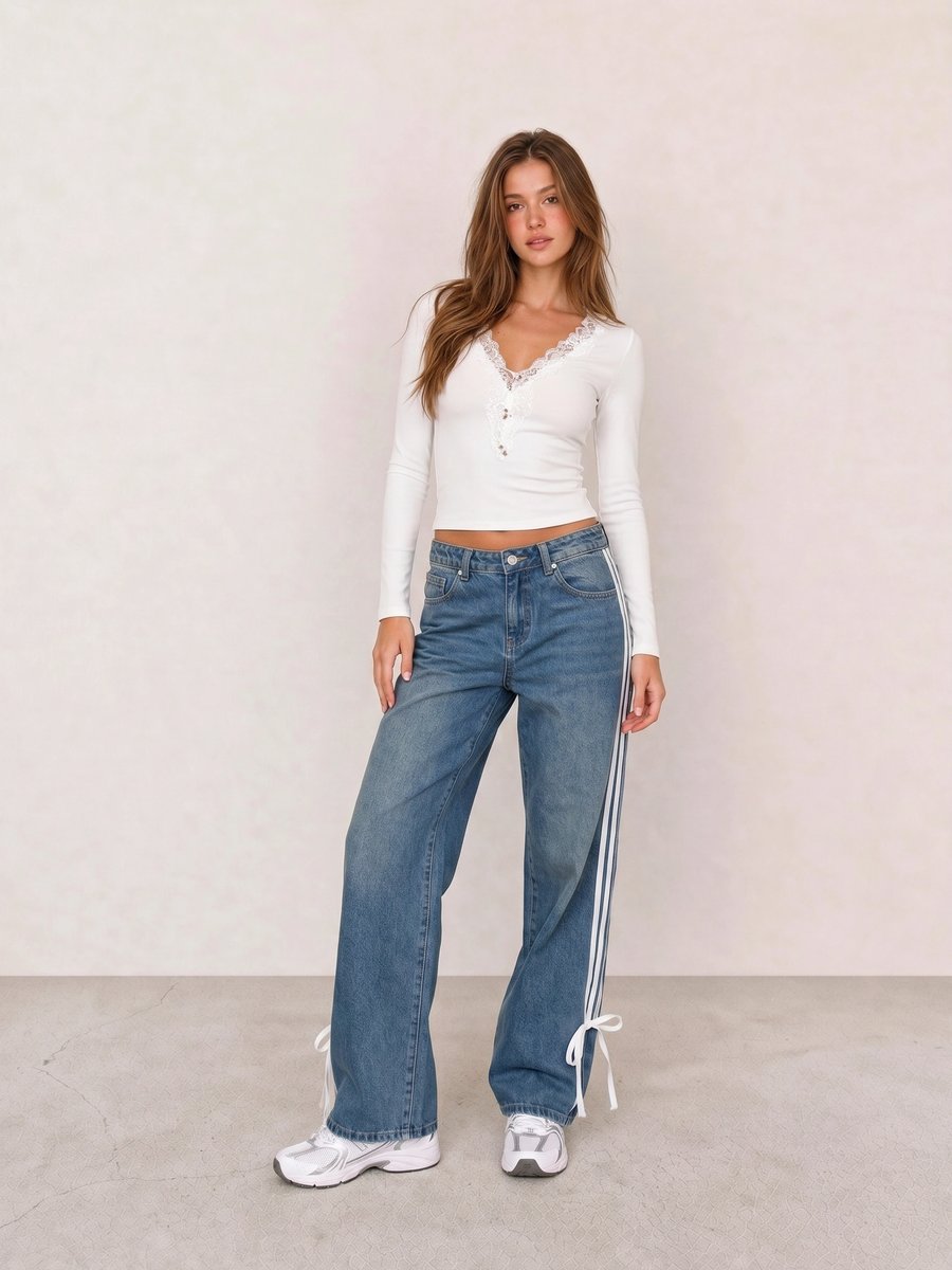 Clean girl outfit with a white lace-trim top, striped wide-leg jeans, and white sneakers