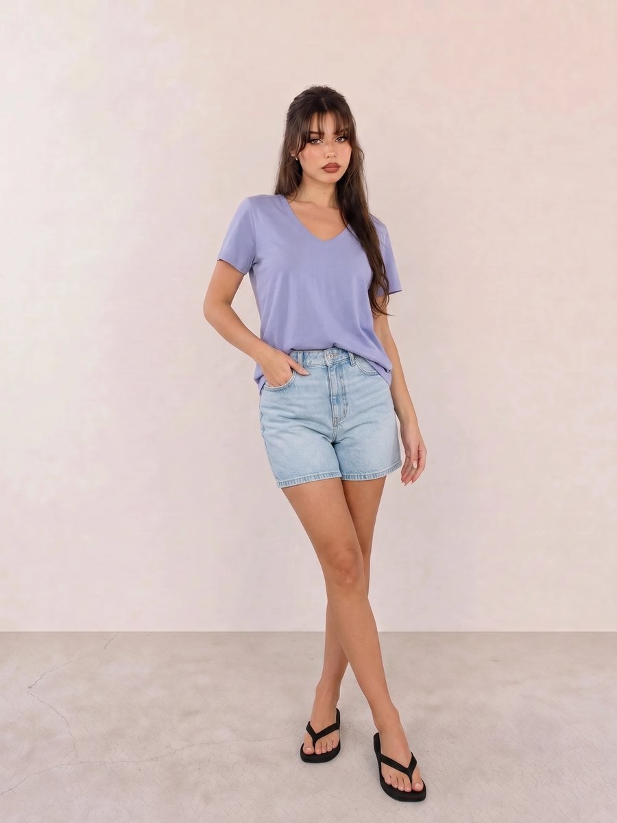 Basic casual outfit with a periwinkle V-neck tee, light wash denim shorts, and black flip-flop sandals