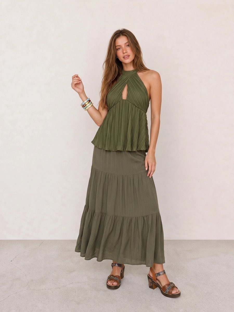 Boho outfit with an olive pleated halter top, tiered olive maxi skirt, and tooled leather platform sandals