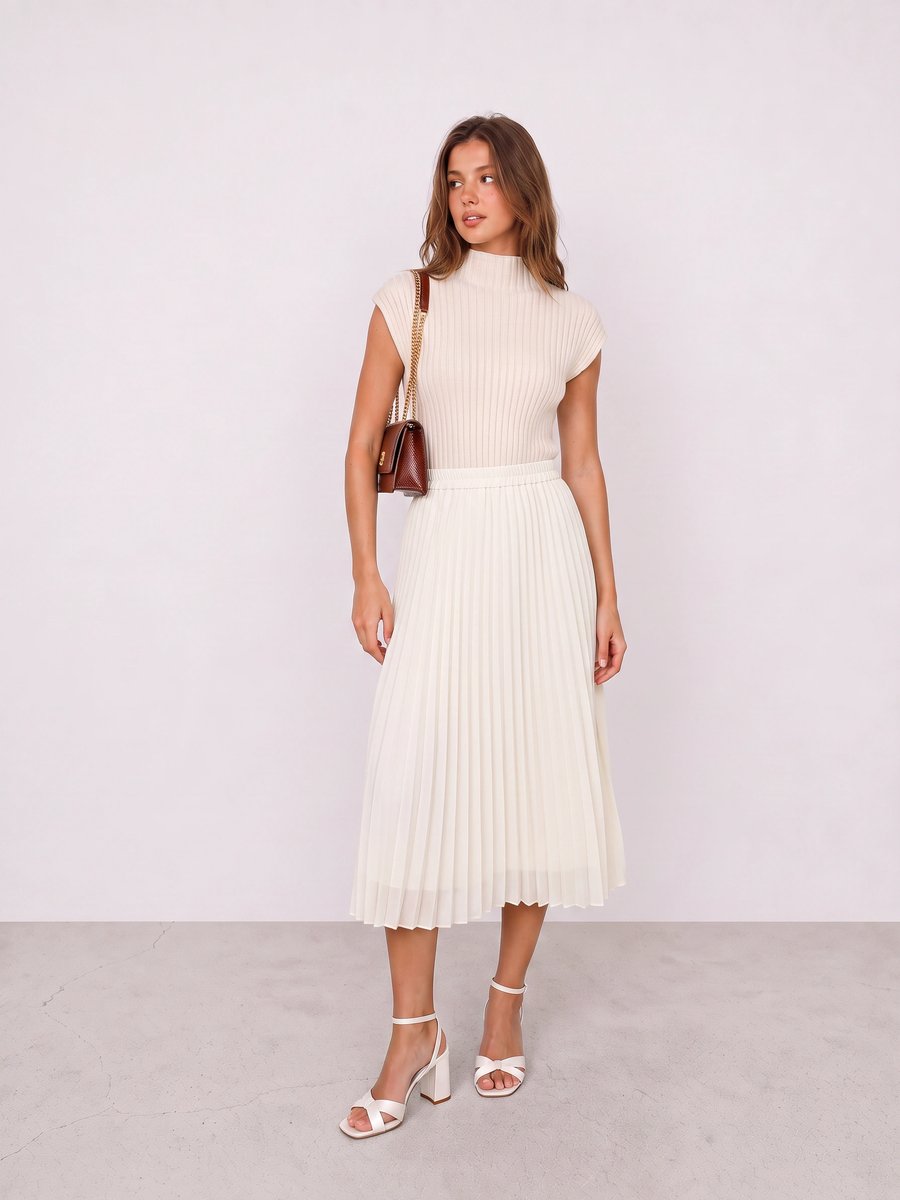 Woman wearing a cream ribbed dress, white sandals, and a burgundy shoulder bag